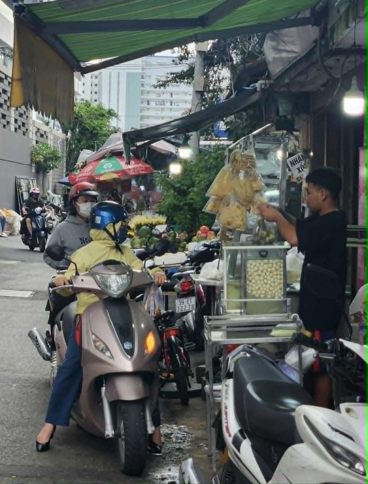 A street food cart and passing motorbikes, part of ethnographic fieldwork
