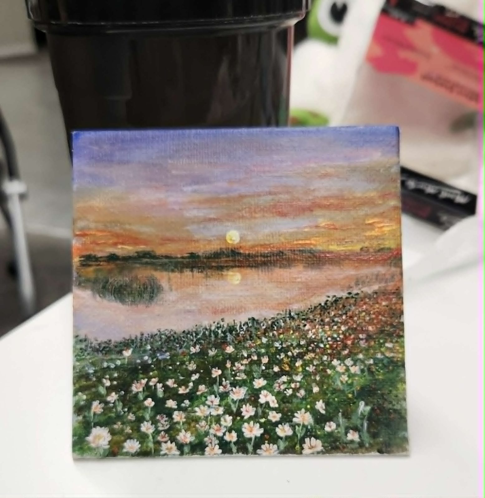 Acrylic painting of a wildflower field at sunset with a full moon
