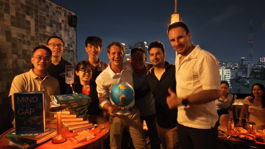 Mind The Gap book launch, rooftop event with book stack and globe