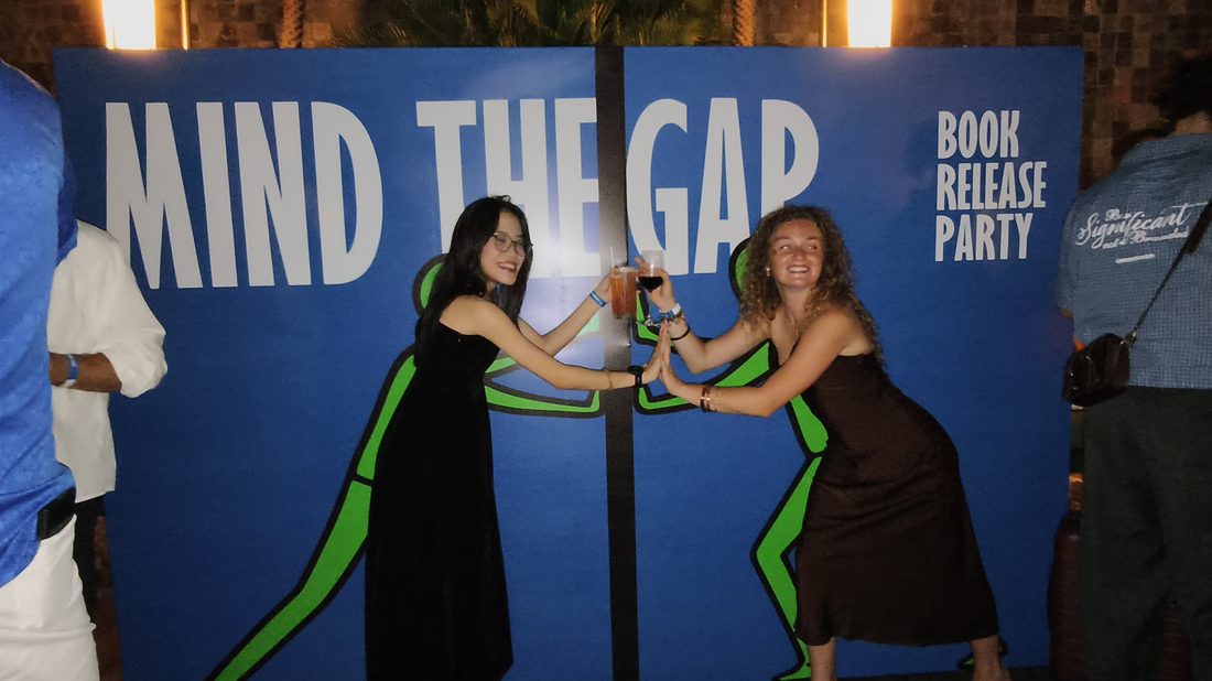 Guests browsing the Mind The Gap photo wall